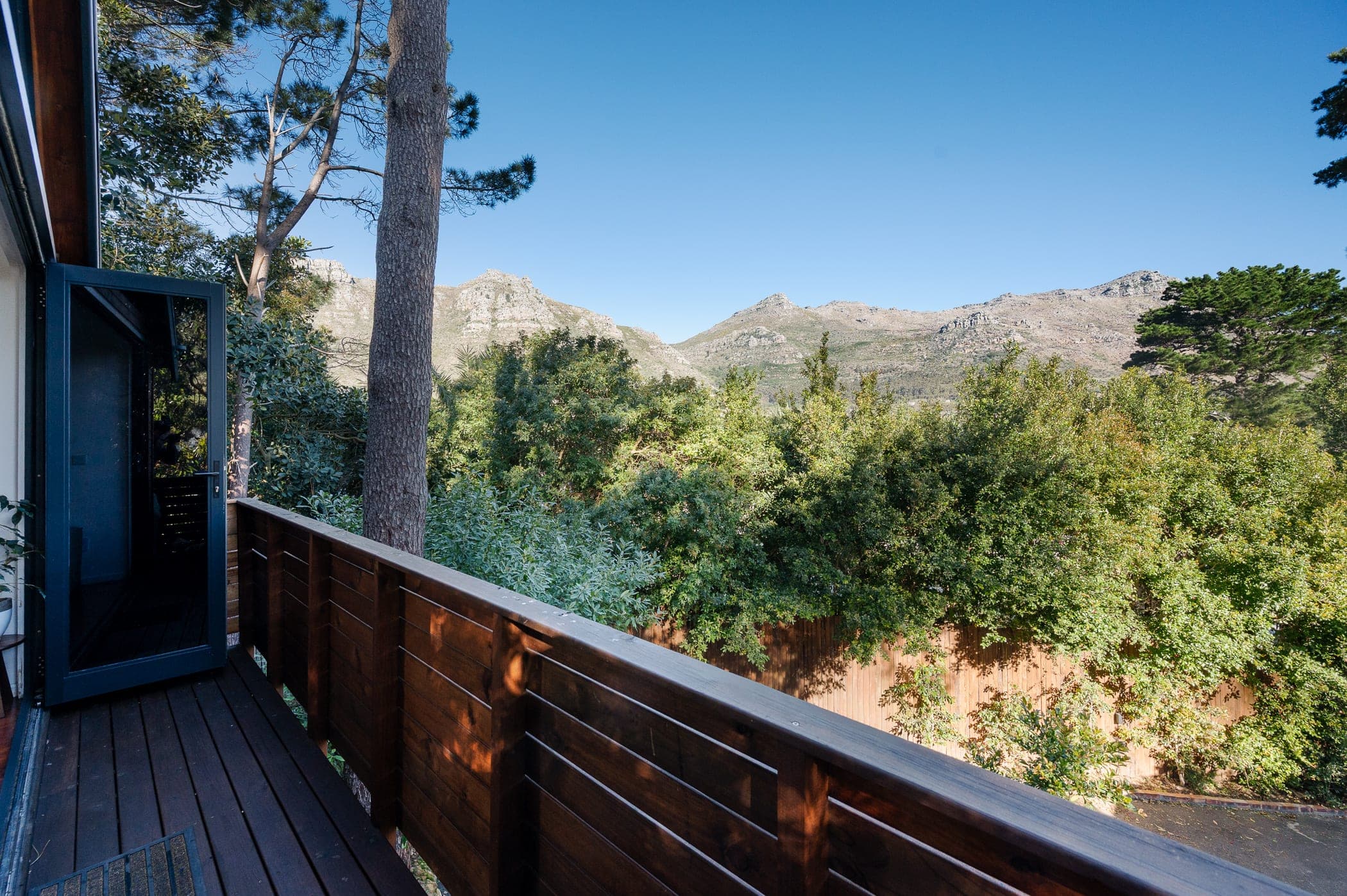 A door opening onto the deck, looking out to the Hout Bay mountains