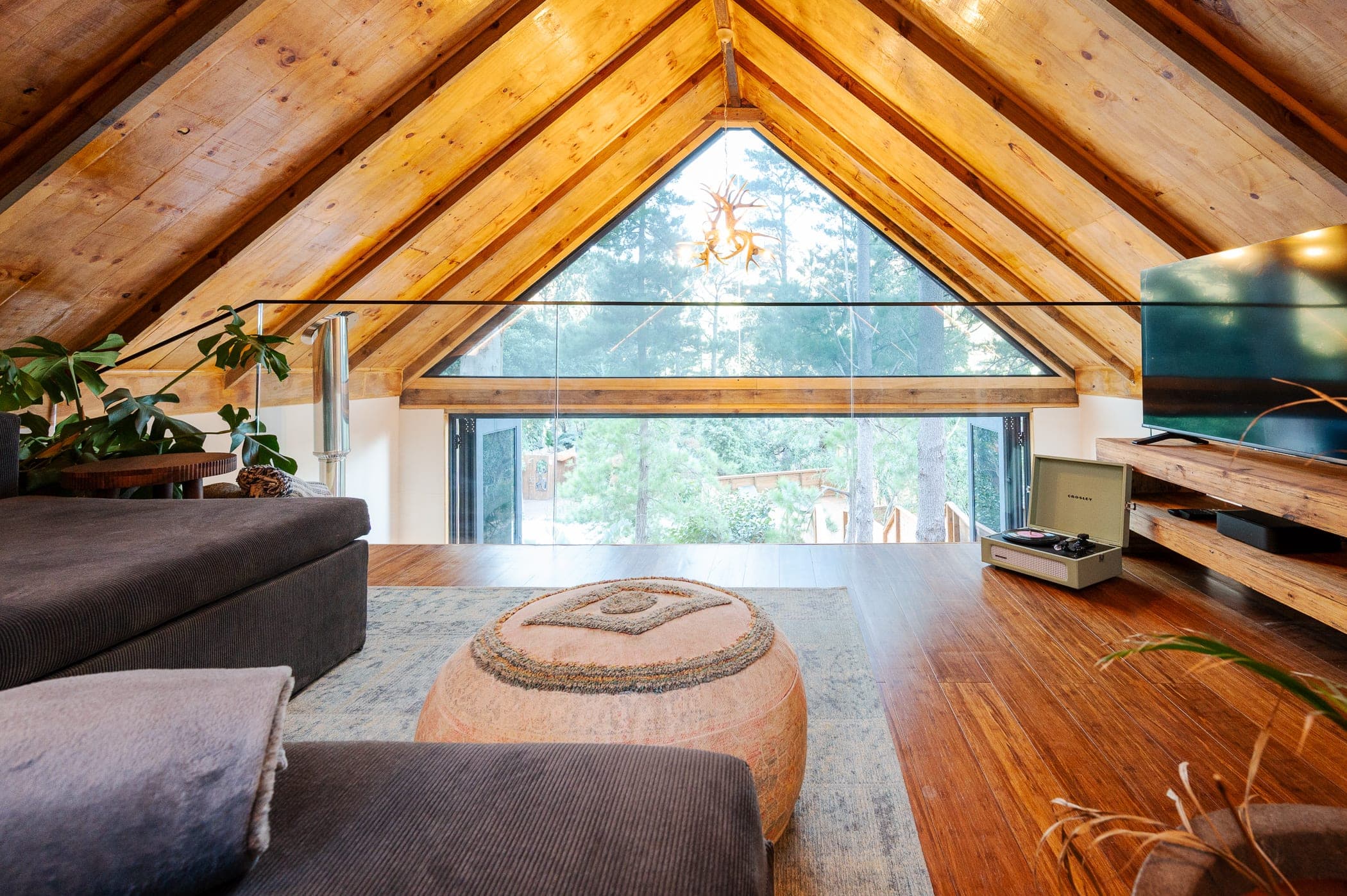 The loft looking down through the gable, antler chandelier at the apex