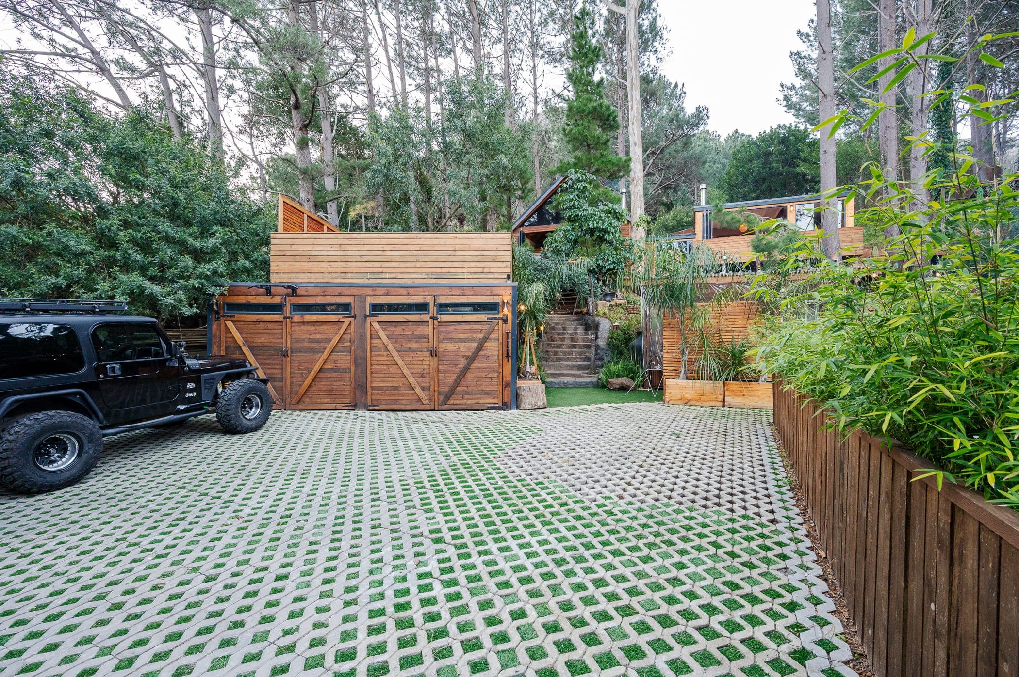 Off-street parking on grass-block paving in front of the timber garage doors