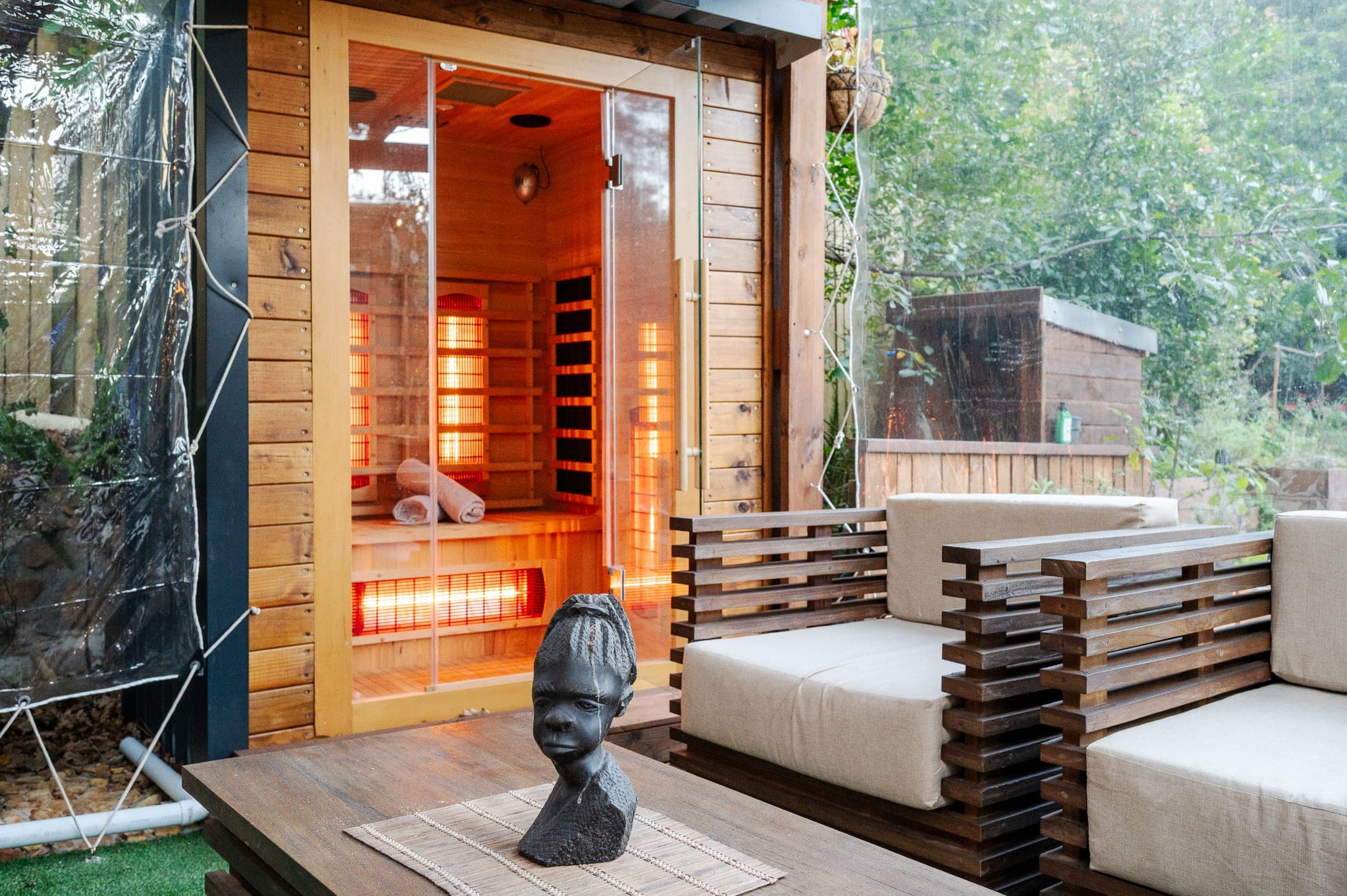 The infrared sauna with its door open, heaters glowing and towels rolled ready